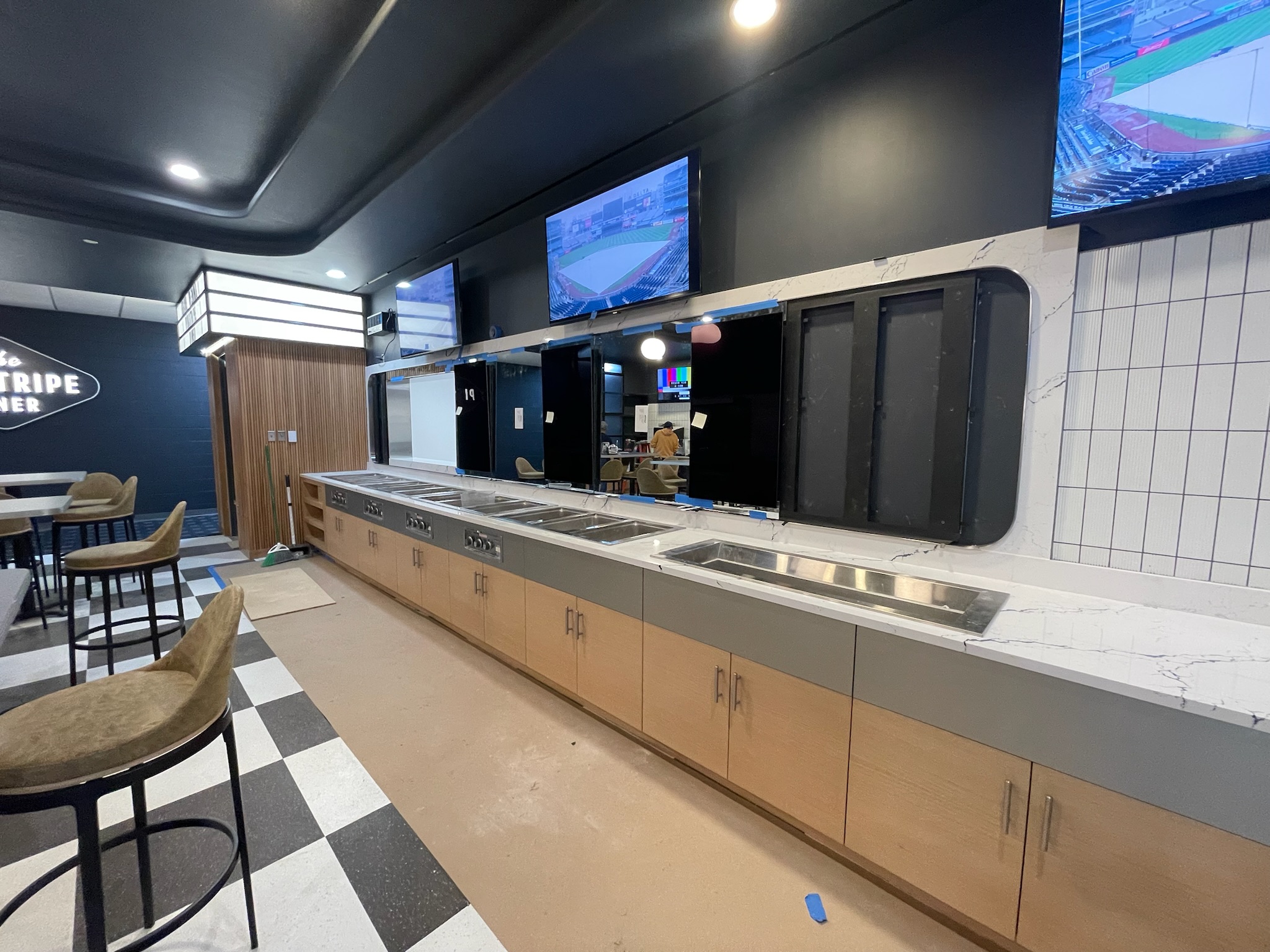 Custom concession counter millwork installation at Yankee Stadium with integrated cabinetry and quartz countertop